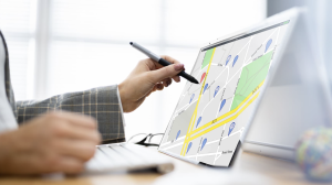 hand searching with a pen on a map_apartment search